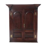 A George III Oak Hanging Corner Cupboard, late 18th century, the breakfront moulded cornice above