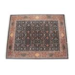 Modern Indian Carpet The deep indigo field of palmettes and scrolling floral vines enclosed by