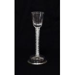 A Cordial Glass, circa 1750, the semi-fluted rounded funnel bowl on an opaque twist stem and ogee