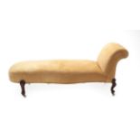 A Victorian Chaise Longue, circa 1870, recovered in yellow fabric with deep overstuffed seat of