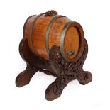 A Black Forest Type Carved Oak Barrel Stand, late 19th/early 20th century, of twin-trestled yoke