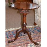 A George III Style Carved Mahogany Tripod Table, the associated pie-crust top above a birdcage