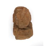 A Carved Sandstone Head, possibly Celtic, of stylised form, 43cm high. Extensively weathered and