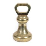 A 28LB Brass Weight, 19th century, the loop handle inscribed 28LB over a bell shaped body, 28cm
