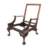 A Carved Mahogany Library Armchair Frame, 18th century in part, with acanthus and scrolled arm
