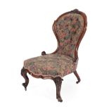 A Victorian Walnut Framed Nursing Chair, circa 1870, recovered in floral and buttoned fabric, the