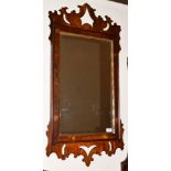 A George II Walnut Parcel Gilt Mirror, the mirror plate contained within a rockwork border, the