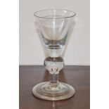 A Heavy Baluster Wine Glass, circa 1720, the rounded funnel bowl on a teared ball knop, plain stem