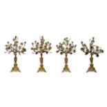 A Garniture of Four French Gilt Metal Candelabra, 19th century, each as an angel supporting an