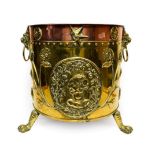 A Dutch Brass and Copper Log Bucket, 19th century, with lion mask and ring handles over relief