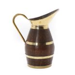 An Oak and Brass Bound Jug, of staved construction, the barrel form body with three brass rivets,