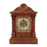 A Walnut Quarter Striking Mantel Clock, circa 1890, arched pediment, brass dial with a silvered