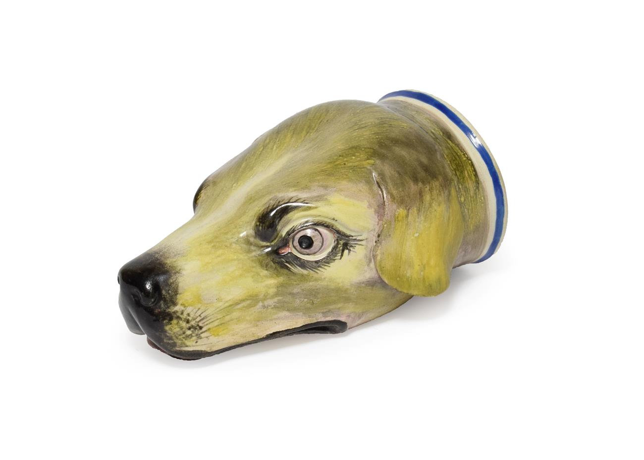 A Pearlware Hound's Head Stirrup Cup, early 19th century, naturalistically modelled and painted, the