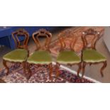 A Set of Four Victorian Carved Walnut Salon Chairs, circa 1860, recovered in green velvet, with