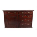 An 18th Century Enclosed Oak Dresser Base, the three plank top above an arrangement of drawers and