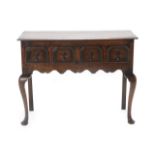 An Oak Side Table or Small Dresser Base, in 17th century style, the moulded top above two