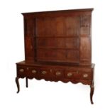 A Late George III Oak and Mahogany Crossbanded Enclosed Dresser, early 19th century, the dentil