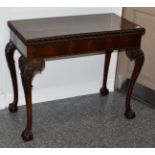 A George III Style Carved Mahogany Foldover Tea Table, 19th century, of rectangular hinged form, the