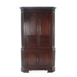 A George III Oak Free-Standing Corner Cupboard, late 18th century, the dentil and fluted cornice