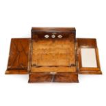 A Victorian Walnut Correspondence Box, the hinged top and twin shaped doors enclosing a fitted