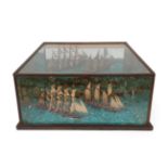 A Ship Diorama, 19th century, modelled with two sailing ships on a choppy sea, an island with