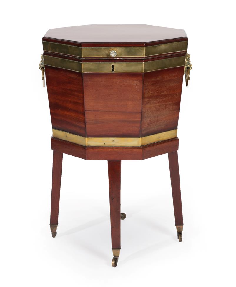A George III Mahogany and Brass Bound Octagonal Cellaret, circa 1800, the hinged lid enclosing a