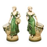 A Pair of Royal Dux Bisque Porcelain Figures of Maidens, early 20th century, loosely dressed