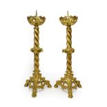A Pair of Neo-Gothic Gilt Metal Candlesticks, mid 19th century, with pierced scroll cast drip