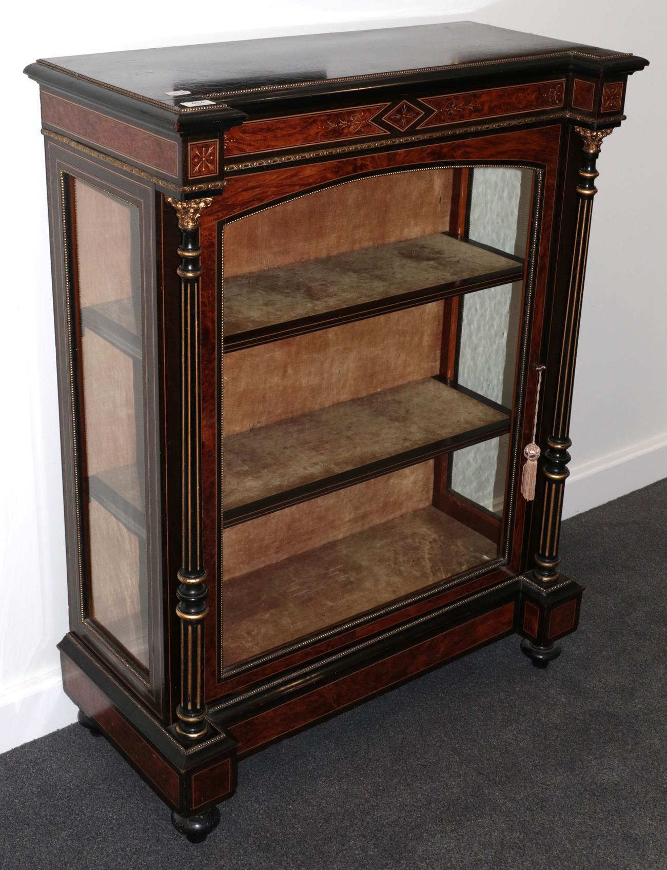 A 19th Century Burr Walnut and Ebonised Pier Cabinet, the single glazed door with shelved interior