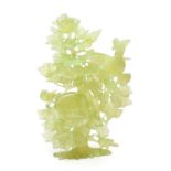 A Chinese Jade Group, as a pheasant perched in a flowering lotus tree, 24cm high. Typical wear to