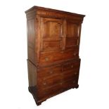 A Joined Oak Secretaire Cabinet, 2nd quarter 18th century, the Greek Key cornice above a parquetry