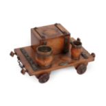 A Metal Mounted Oak Novelty Desk Stand, early 20th century, modelled as a railway cart with a