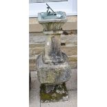 A sundial raised upon a stone pedestal