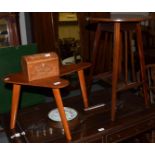 An Edwardian mahogany occasional table, a 1950's table, a 19th century tea caddy and a wheel