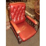 A Victorian red leather button upholstered armchair (leg repaired)