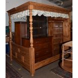 A pine kingsize full tester bed, panelled headboard and canopy, 224cm high by 230cm long by 180cm