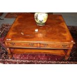 A burr walnut veneer square form coffee table, comprising four side drawers, from Barker &