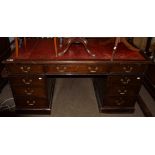 A 19th century mahogany twin-pedestal desk, red leather inset above an arrangement of nine drawers