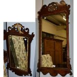 A large Georgian fret cut wall mirror, 112cm high, together with a similar smaller mirror