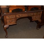 A late 19th century mahogany kneehole desk in the Chippendale style, green leather inset,