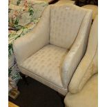 A 19th century mahogany framed armchair in ivory coloured floral upholstery, with cabriole legs
