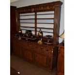 An 18th century style oak dresser, by Belvedere, moulded and carved cornice above three open