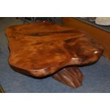 A modern coffee table, top made from single slice of timber on a root base, 130cm diameter