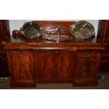 An early 19th century mahogany twin-pedestal sideboard, gallery back, three cushion drawers above