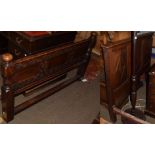 An oak framed double bed in the 17th century style with panelled head and foot board, 138cm wide