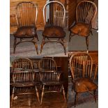 A set of six 19th century style elm seated stick back chairs including two carvers, by Walker's of