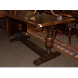 An oak refectory table, with cup and cover supports and trestle base, 152cm long