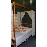 A beech four-poster bed with a Heal & Son Ltd sprung bed base, the underside stamped Ingle