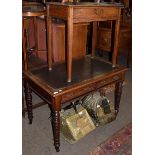 A late 19th century writing desk, leather inset with twin drawers on turned legs and castors 106cm