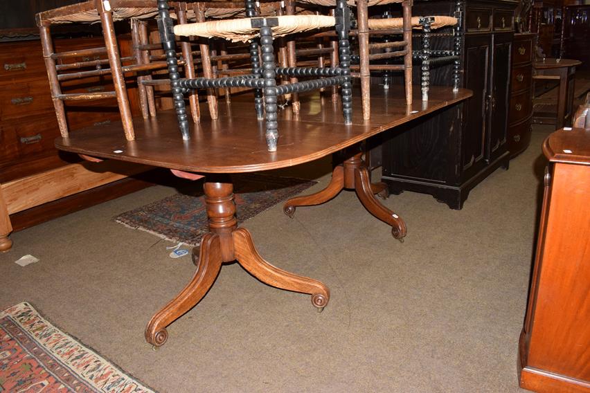 A 19th century mahogany D-end dining table, with a single leaf raised on twin tripod bases, 185cm